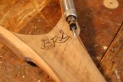 The initials are carved out free-hand, then inlaid in Brass