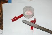 Grinding up red fire coral for inlay