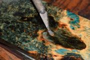A Bullet embedded inside a custom Maple burl fly fishing net handle by Sierra Nets